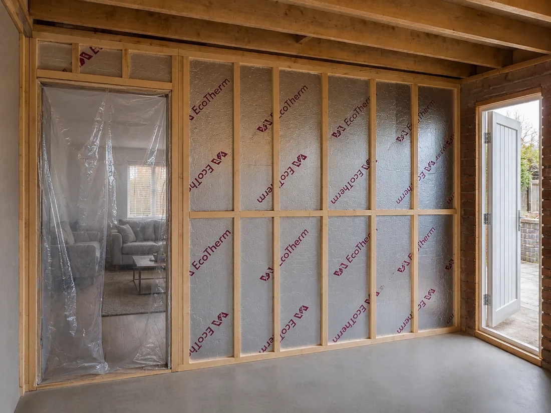 Real Vision Builder job: rigid insulation boards fitted between timber studs in a partition wall