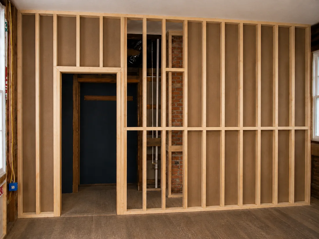 Real Vision Builder job: timber stud partition wall with a doorway opening framed, first fix before boarding