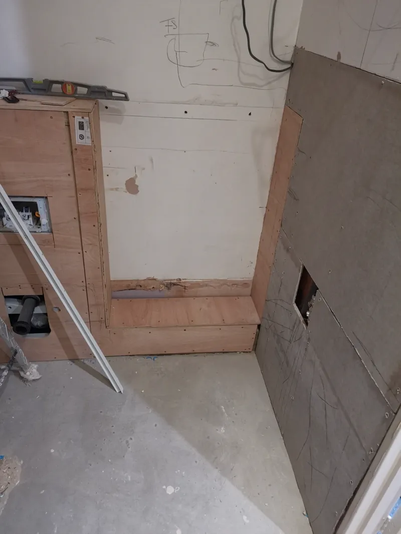 First-fix electrical board fitted under a loft eaves, wiring visible.